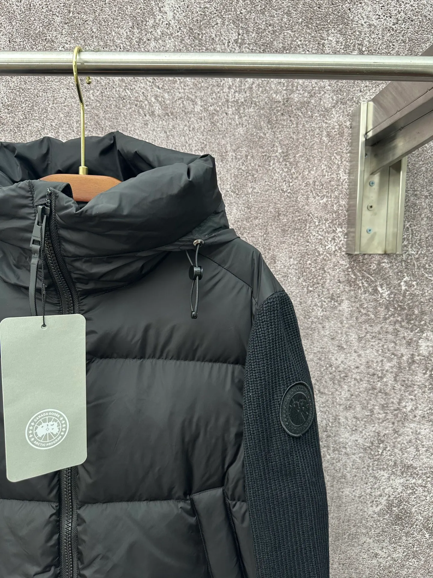 P930 Canada Goose Armband Hooded Down Jacket Fabric selection: The use of high-quality protective nylon fabric not only enhances the wear resistance of the surface, but also takes into account wind resistance, ensuring excellent performance in various harsh weather conditions.  90 national standard high-quality white duck down: selected high-loft down, weighing 170g, light and warm, with excellent temperature locking performance and good resilience.  Three-dimensional quilting process: Precision thread reinforcement to prevent velvet drilling and ensure that the fluffy and resilient elasticity lasts as new.  7-needle medium-thick knitted structure: Use thicker yarns to knit woolen fabrics with obvious thickness and weight. The texture is clearly visible and has a rough, retro texture. It has a good skeleton feel, is relatively stiff, and can maintain the silhouette of clothing for a long time. It also provides more layers of still air to lock in heat.  There is a brand exclusive LOGO on the woolen sleeve arms. It is dark and not obvious in the photo.  Accessories: One-to-one customized logo, one-to-one customized zipper pendant, one-to-one customized snap button SIZE: S M L XL